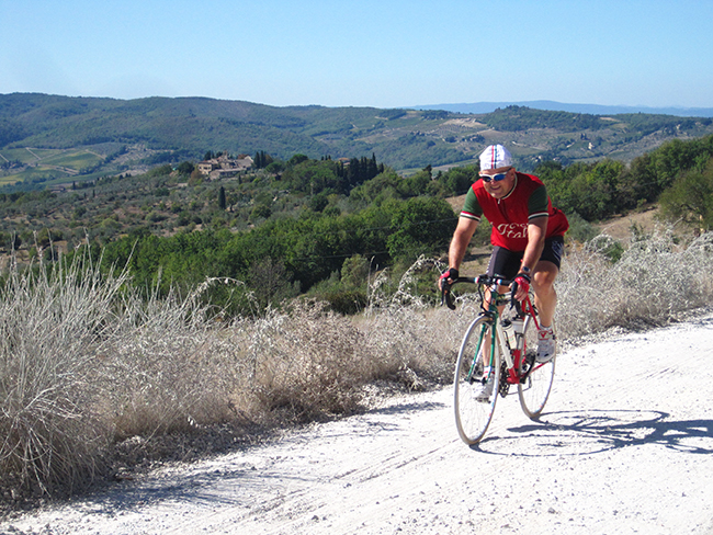 Cyclist in countryside in Italy